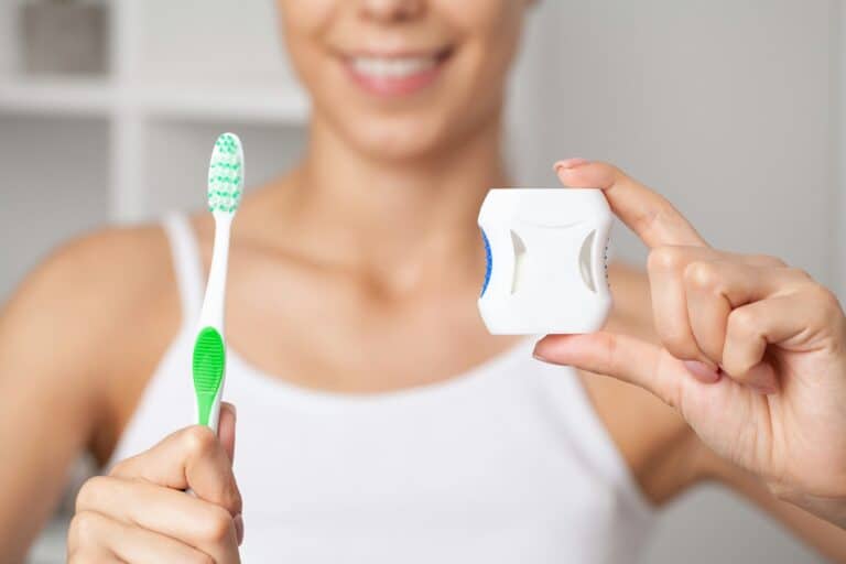 Oral hygiene and health care, smiling women use dental floss white healthy teeth.