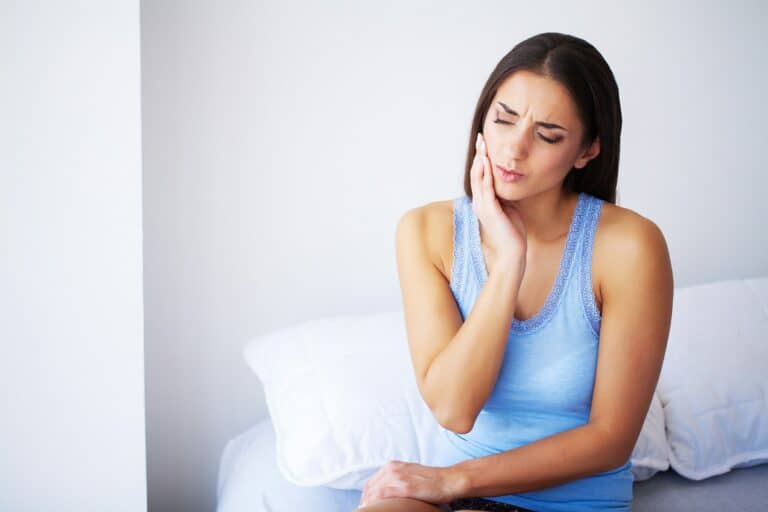 Teeth Pain. Beautiful Woman Suffering From Painful Toothache